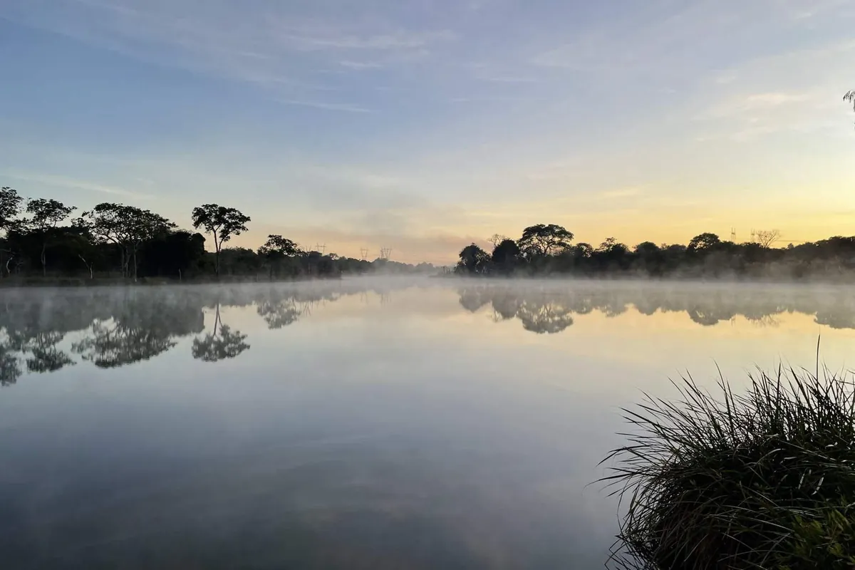 Mist drifting over still water at first light at Baluba Game Resort